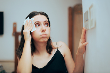 woman feeling the heat at home