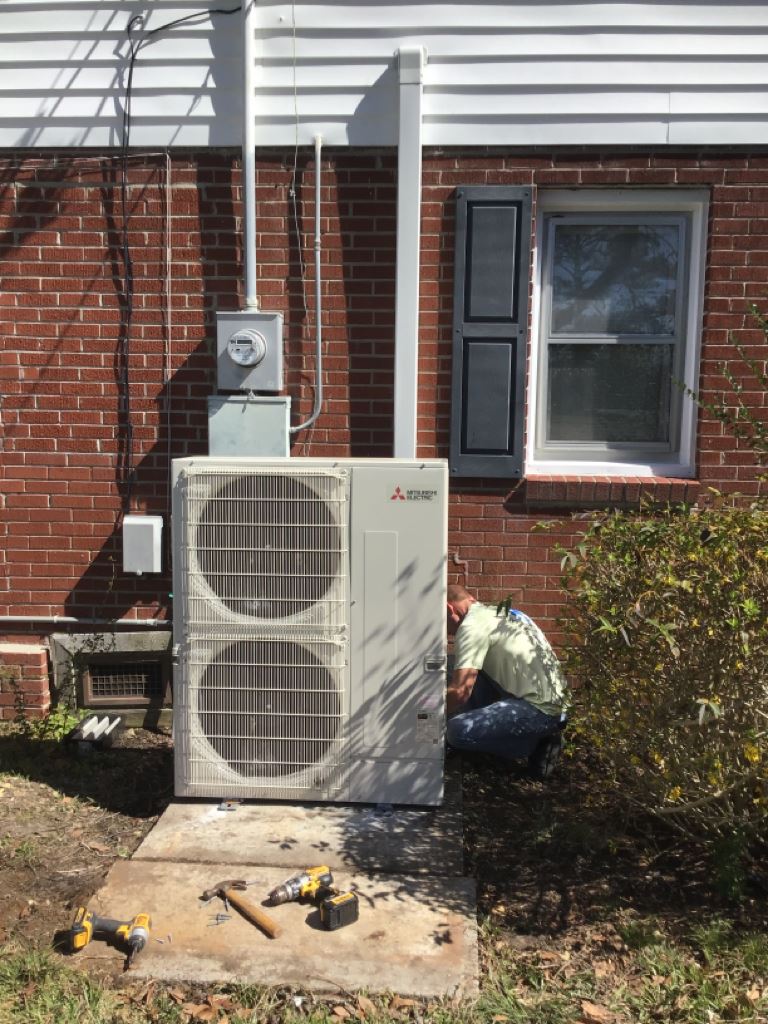 Man Installing Mitsubishi Electric All-Electric Heat Pump System