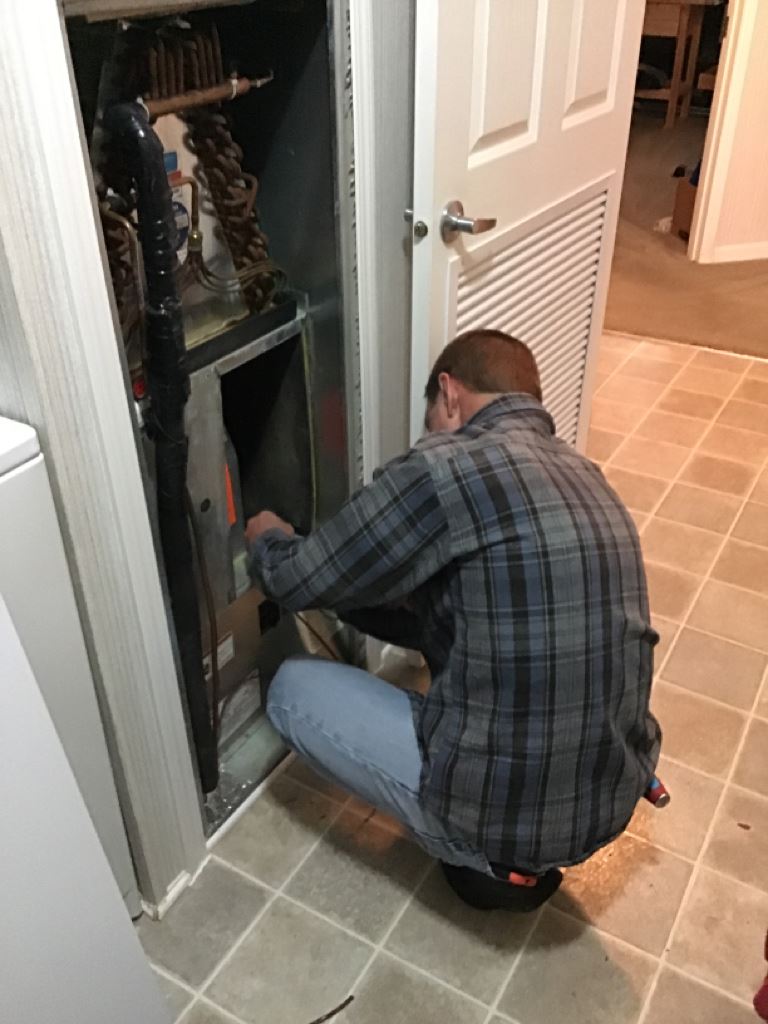 Man Servicing AC Unit